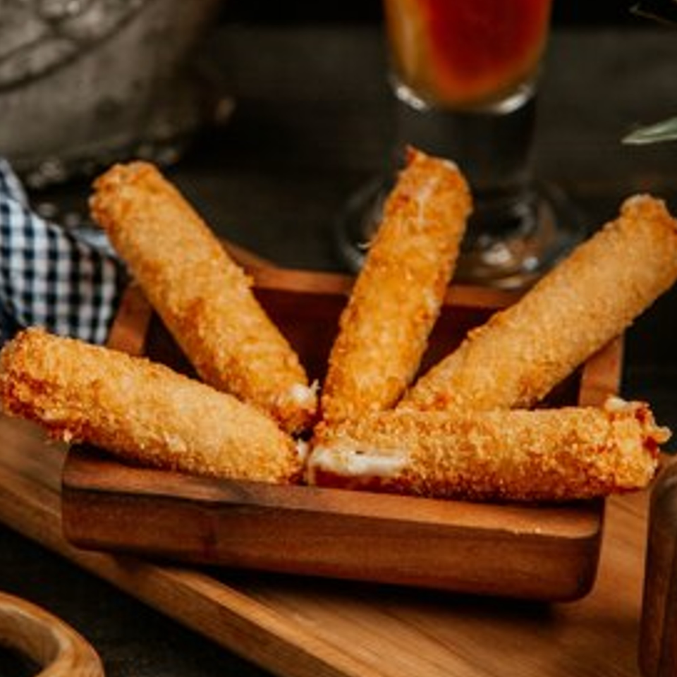 Four golden-brown mozzarella sticks, some with melted cheese visible, in a rustic wooden holder.